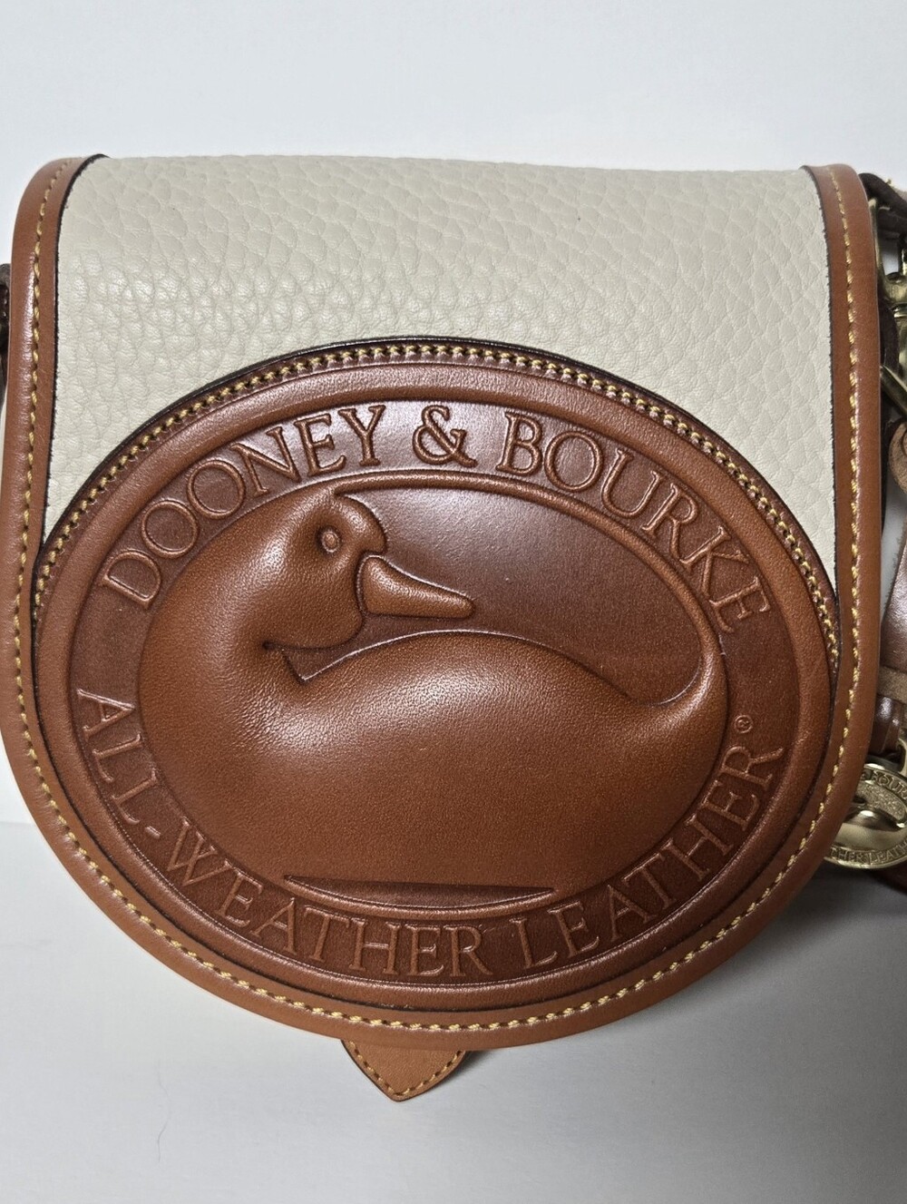 Dooney & Bourke Cream Pebbled Leather Crossbody Duck Bag with Brown Trim